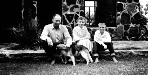 photo of a young Fess Parker seated on the front stoop with his family