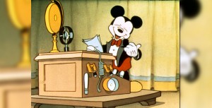 Mickey standing at a podium