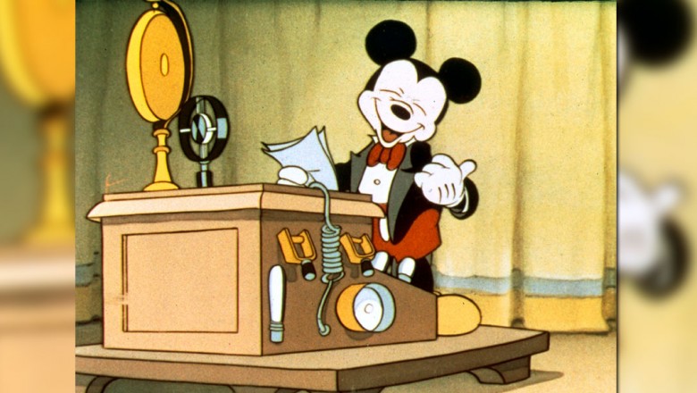 Mickey standing at a podium