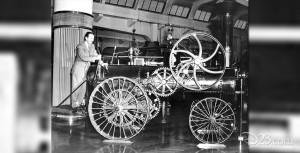 photo of Walt Disney working levers at the font of a steam powered fire engine on display while visiting Chicago Railroad Fair in 1948