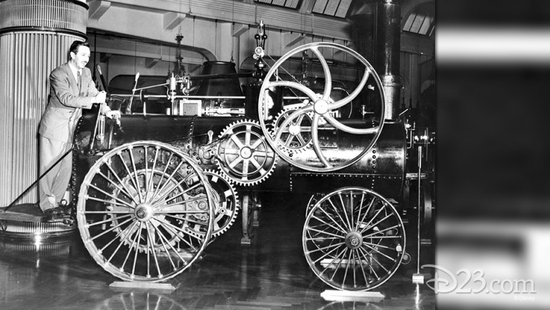 photo of Walt Disney working levers at the font of a steam powered fire engine on display while visiting Chicago Railroad Fair in 1948