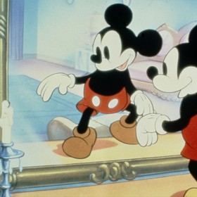 Mickey standing in front of a mirror