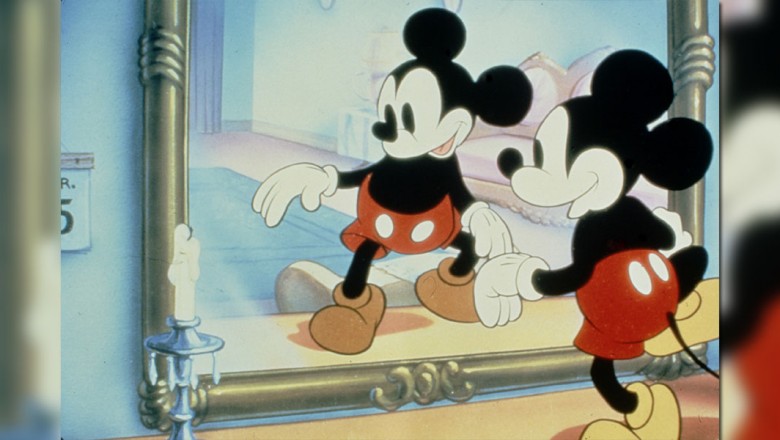 Mickey standing in front of a mirror