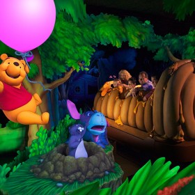 People riding The Many Adventures of Winnie the Pooh at Disneyland