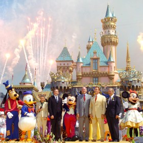 group photo of celebration at Disneyland featuring, Pictured from Left to Right: Diane Disney Miller, Bob Iger, Michael Eisner, Governor Arnold Schwarzenegger, Art Linkletter