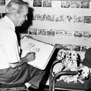 photo of animator Eric Larson sketching live dalmatian puppies
