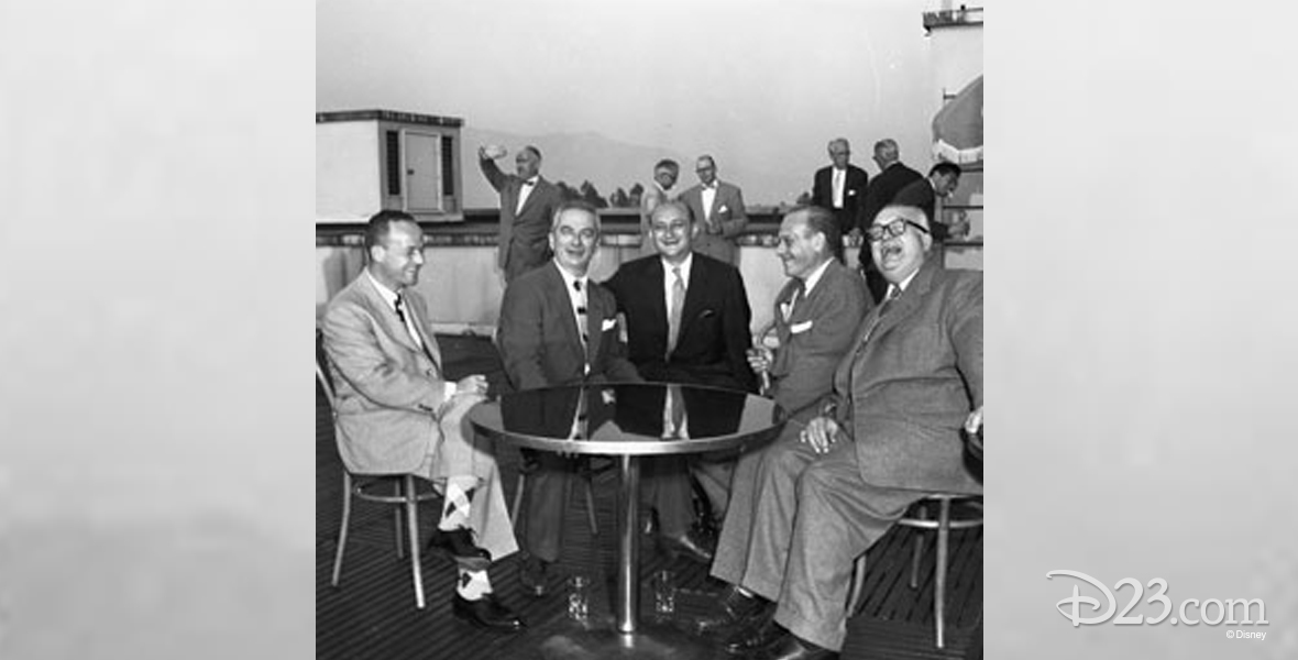 photo of men in suits sharing laughs on the rooftop penthouse club of the animation building