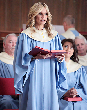 production still from GCB featuring actress Kristin Chenoweth singing in a choir dressed in choir robe