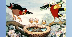 frame from Birds in the Spring (film) showing three baby birds nestled with mama and papa birds nearby