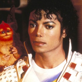 photo of Michael Jackson in costume as Captain EO with small pet monkey on one shoulder