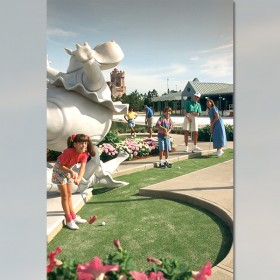 photo of family of four on putt-putt greens of Fantasia Gardens Miniature Golf and Garden Pavilion