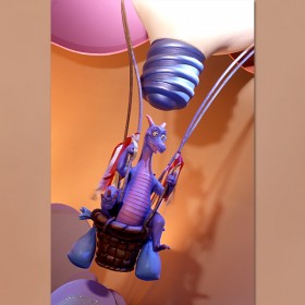 photo of Figment, a purple dragon figurine riding in a hot-air balloon basket