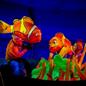 stage production photo of brightly costumed characters in Finding Nemo—the Musical