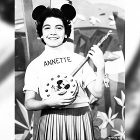 photo of young Annette Funicello wearing Mouseketeer cap and holding a banjo