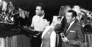 Walt Disney standing with Imagineers