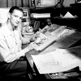 photo of John Lounsbery at his drawing table