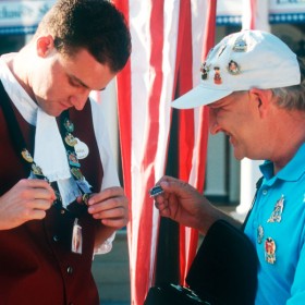 Photo of two men pin trading at Disneyland