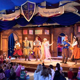 photo of stage production with ensemble medieval characters at Fantasy Faire at Disneyland