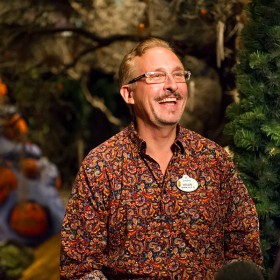 photo of Haunted Mansion Holiday Art Director Brian Sandahl amid his holiday decorations for the attraction