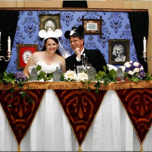 photo of Jason Thompson and new bride Melissa at head table of their Haunted Mansion-themed wedding and reception