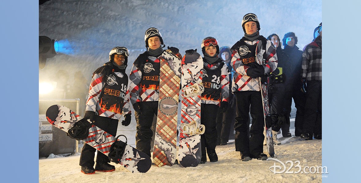 photo of group of young people dressed for winter sports, each person holding a snowboard