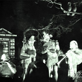 black and white photo of ghost players amidst tombstones from Disneyland's The Haunted Mansion