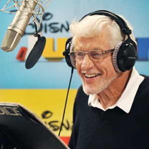 photo of Dick Van Dyke in recording booth wearing headphones