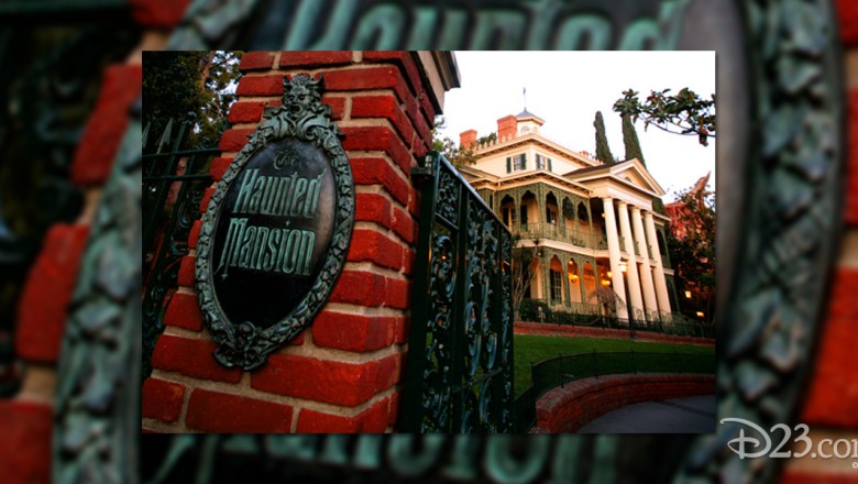 photo of entrance gate and bronze sign for Haunted Mansion at Disneyland