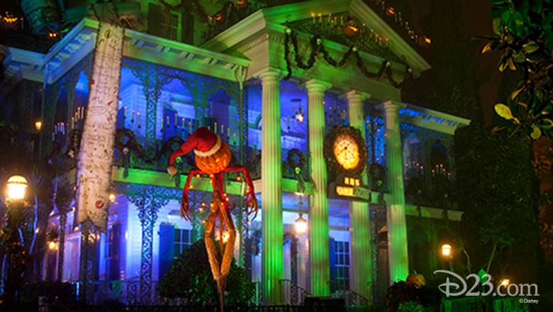 photo of The Haunted Mansion at Disneyland Resort decorated and all lit up for the holidays