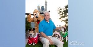 photo of host seated with Goofy character and two dogs in costume from America's Cutest: Disney Side Howl-0-Ween