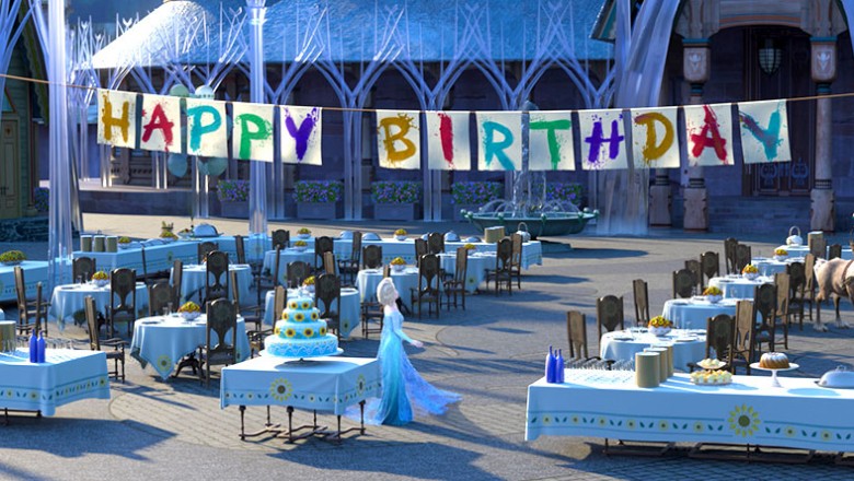 still from animated short Frozen Fever showing Elsa and Kristoff in a huge reception hall decorated with large hanging letters Happy Birthday Anna