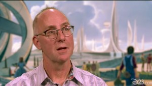 photo of art director Ramsey Avery in front of illustration of Tomorrowland from the movie Tomorrowland