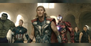 still from the movie The Avengers showing all superheroes assembled in a line inside massive hall