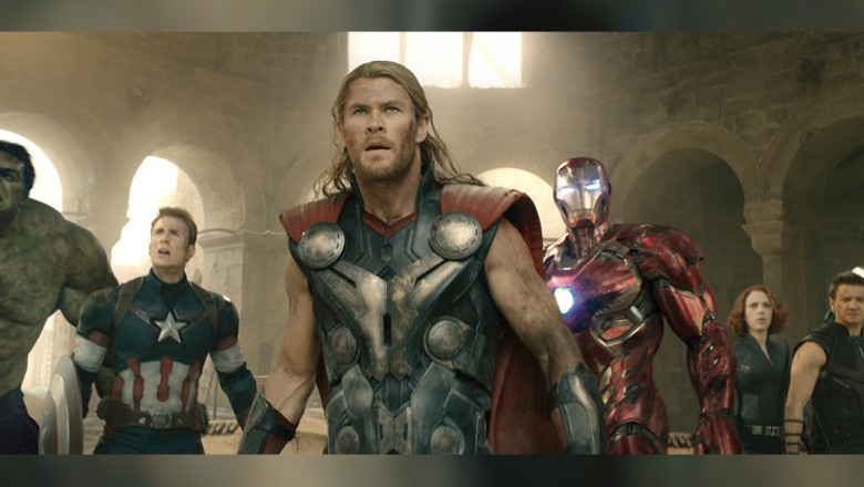 still from the movie The Avengers showing all superheroes assembled in a line inside massive hall