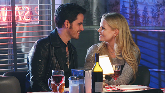 production still of actors COLIN O'DONOGHUE and JENNIFER MORRISON seated close together in a romantic restaurant at night