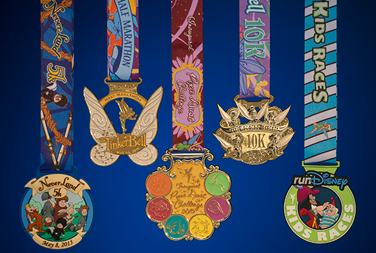 photo of five colorful medals hanging from ribbons for Tinker Bell Half Marathon Weekend