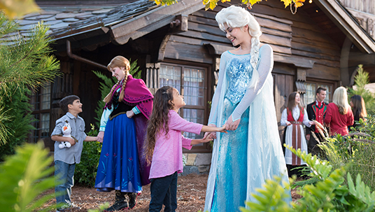 photo of children visiting cast members playing royal sisters Elsa and Anna of Arendelle from the movie Frozen