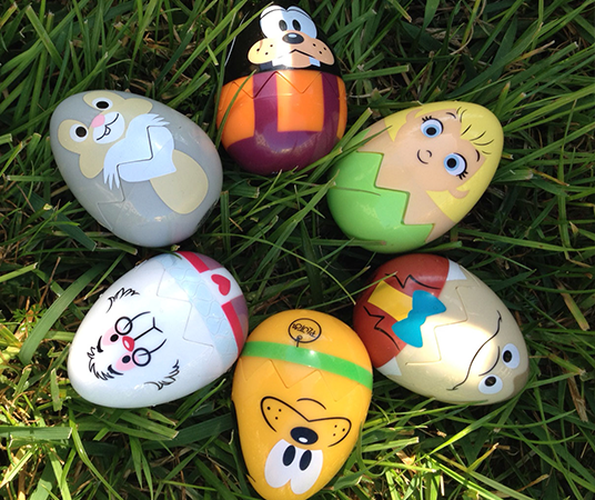 photo of six plastic toy eggs with a painted Disney character on each one