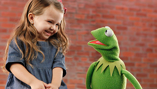 photo of little girl laughing at Kermit the Frog