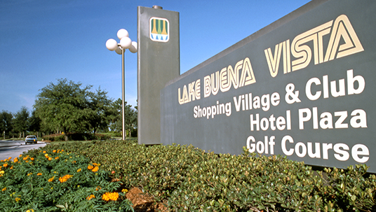 photo of sign at entrance with text Lake Buena Vista Shopping Village & Club Hotel Plaza Golf Course