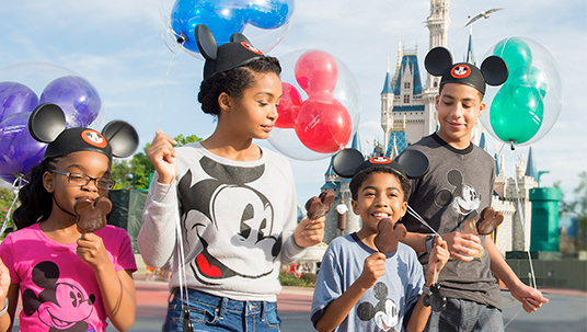 photo of two young boys and two young girls eating Mickey Mouse frozen fudge sticks