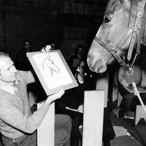 Studio art teacher Bernard Garbutt showing his drawing to a horse.