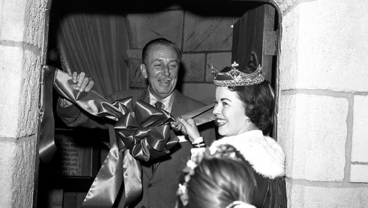 photo of actress Shirley Temple Black helping Walt Disney rededicate Sleeping Beauty Castle at Disneyland on April 29, 1957