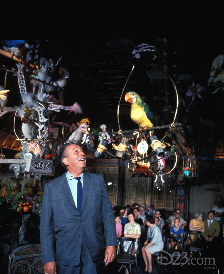 photo of Walt talking to Jose the Parrot in enchanted tiki room as seated guests watch from background
