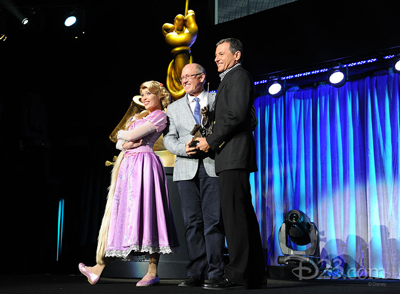 Glen Keane and Rapunzel receiving a Disney Legend Award from Bob Iger
