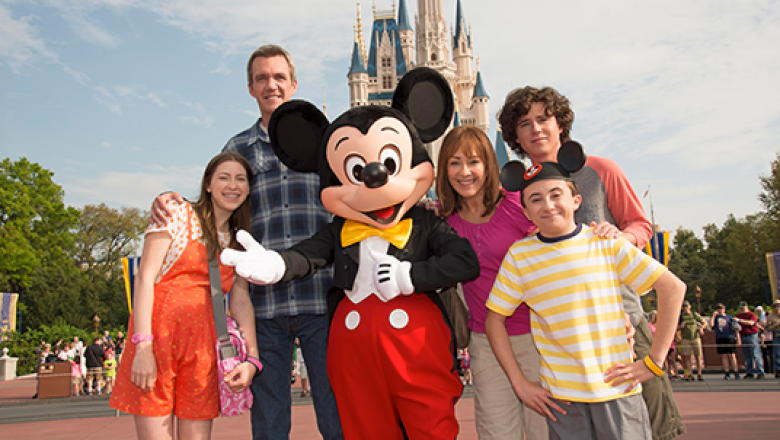 Family standing with Mickey Mouse