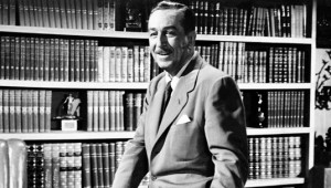 photo of Walt Disney seated in library