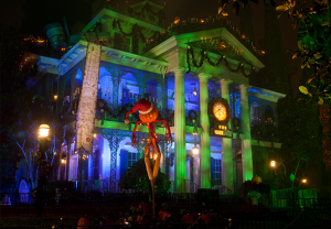 photo of The Haunted Mansion at Disneyland Resort decorated and all lit up for the holidays