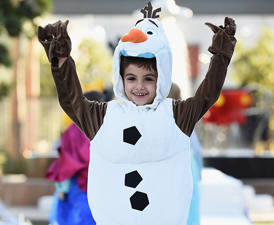 photo of little boy showing off his Olaf the snowman costume
