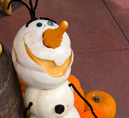 photo of pumpkin carved and painted to resemble the character Olaf from the animated feature Frozen